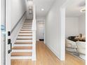 Elegant staircase with hardwood steps and white risers, leading to the upper level at 332 Gibson Se St, Atlanta, GA 30316