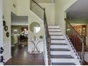 Inviting foyer with staircase, hardwood floors, and elegant decor, leading to dining area at 4089 Palm Dr, Snellville, GA 30039