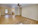 Open living area with wood floors and a view of the modern, updated kitchen at 61 Andrew Rd, Covington, GA 30016