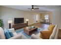 Bright living room with wood floors, modern furniture, and an open dining area at 61 Andrew Rd, Covington, GA 30016