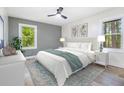 Bright bedroom with light gray walls, natural light, and a ceiling fan at 3185 Hammarskjold Dr, East Point, GA 30344
