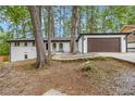 Inviting exterior view of a single-story home with well-maintained landscaping and attached garage at 3185 Hammarskjold Dr, East Point, GA 30344