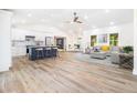 Open floor plan showcasing the kitchen, living room, and dining area with sleek hardwood floors at 3185 Hammarskjold Dr, East Point, GA 30344