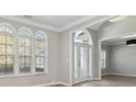 Inviting entryway with hardwood floors, arched windows, and a view into the adjacent living spaces at 4114 Bigsage Dr, College Park, GA 30349