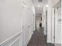 Bright hallway featuring pristine white walls, dark hardwood floors, and classic trim at 515 Vandenburg Dr, Villa Rica, GA 30180
