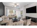 Comfortable living room with modern decor, large windows, and a ceiling fan at 515 Vandenburg Dr, Villa Rica, GA 30180
