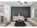 Cozy living room with neutral-colored furniture, a dark accent wall, and decorative rug at 515 Vandenburg Dr, Villa Rica, GA 30180