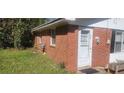 A single story brick home with a white front door and three adjacent white framed windows at 106 #2 Woodhaven Dr, Jonesboro, GA 30236