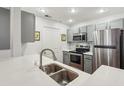 This kitchen has stainless steel appliances, gray cabinets, white countertops, and a stainless steel sink at 1101 Juniper Ne St # 415, Atlanta, GA 30309