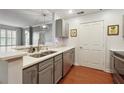 Modern kitchen with stainless steel appliances, white countertops, and gray cabinets at 1101 Juniper Ne St # 415, Atlanta, GA 30309