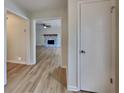 Inviting entryway leading to a spacious living room with a stone fireplace and hardwood flooring at 6413 Swift Creek Dr, Lithonia, GA 30058