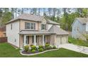 Attractive two-story home featuring a blend of stone and brick, a covered porch, and an attached two-car garage at 6917 Demeter Dr, Atlanta, GA 30349