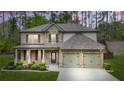 Beautiful two-story home with stone and brick accents, complemented by a well-manicured front yard and two-car garage at 6917 Demeter Dr, Atlanta, GA 30349
