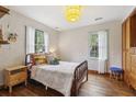 Cozy bedroom with hardwood floors, decorative wallpaper, and plenty of natural light at 1015 S Candler St, Decatur, GA 30030