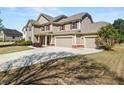 Spacious home with a large driveway, three-car garage and manicured landscaping at 2881 Terra View Sw Dr, Lilburn, GA 30047