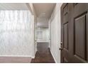 Inviting hallway features hardwood floors, neutral paint, and elegant marble-patterned accent wall at 3314 Tiara Cir, Atlanta, GA 30311
