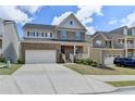 Charming two-story brick home boasts a covered porch, two-car garage, and well-maintained landscaping at 4349 Northmark Ln, Buford, GA 30518