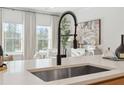 Close-up of a kitchen with a sleek stainless steel sink and modern fixtures at 440 Carrera Ln, Acworth, GA 30102