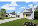 Cozy single-story home with a bright yellow door, front porch, attached garage, and green lawn at 131 Magazine St, Dallas, GA 30157