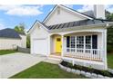 Charming single-story home featuring a yellow front door, inviting front porch, and attached garage at 131 Magazine St, Dallas, GA 30157