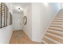 Inviting entryway featuring wood floors, a stylish mirror, and staircase at 432 Carrera Ln, Acworth, GA 30102