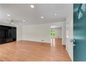 Bright living room with hardwood floors, recessed lighting, and a decorative ceiling fan at 2310 Kings Point Dr, Atlanta, GA 30338