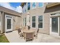 Cozy outdoor patio area with a round table and four chairs, perfect for relaxation and entertaining at 5450 Fieldfreen Dr, Cumming, GA 30028