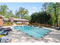 Inviting backyard pool with lounge chairs and mature trees for privacy at 629 Concord Sw Rd, Smyrna, GA 30082