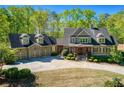 Beautiful two-story house with a well-manicured lawn and a spacious driveway to a three-car garage at 1000 Holly St, Canton, GA 30114