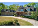 Charming two-story home with a well-kept lawn and beautifully landscaped front yard at 1000 Holly St, Canton, GA 30114