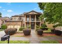 Charming two-story brick home with a columned porch and a well-manicured front yard at 265 Lily Cove Dr, Loganville, GA 30052