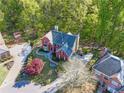 Aerial shot of house and lush green surroundings with mature trees, in daytime at 2740 Stonehill Way, Cumming, GA 30041
