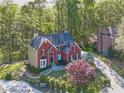 Aerial view of brick house surrounded by mature trees and manicured landscape at 2740 Stonehill Way, Cumming, GA 30041