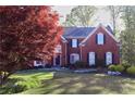 Beautiful two-story brick home with well-manicured lawn and mature landscaping at 2740 Stonehill Way, Cumming, GA 30041