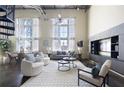 Open-concept living room with high ceilings, natural light, modern furnishings, and spiral staircase at 572 Edgewood Ne Ave # 301, Atlanta, GA 30312