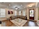 Spacious living room with hardwood floors, ample seating, and a welcoming atmosphere at 6425 Bellmoore Park Ln, Johns Creek, GA 30097