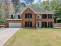 Charming two-story brick home with black shutters, dormer windows, and a well-manicured front lawn at 1960 Barnes Mill Rd, Marietta, GA 30062