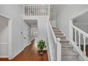 Spacious foyer with hardwood floors, staircase with white railings, and an open view of the home's interior at 1960 Barnes Mill Rd, Marietta, GA 30062