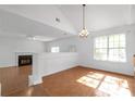 Open dining room featuring a modern chandelier, fireplace, and tile flooring at 2565 Feywood Ct, Lithonia, GA 30058