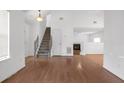 Open-concept living area with hardwood floors, staircase, and fireplace at 2565 Feywood Ct, Lithonia, GA 30058