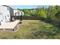 Large backyard featuring a patio with outdoor dining and a spacious grassy area at 269 Shoals Bridge Rd, Acworth, GA 30102