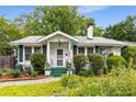 Charming home featuring a well-manicured lawn and a inviting front porch at 4 Arc Ne Way, Atlanta, GA 30305