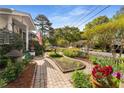 Lovely landscaped yard with brick path and a charming front porch at 4 Arc Ne Way, Atlanta, GA 30305