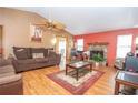 Cozy living room featuring a stone fireplace, ceiling fan, and wood flooring at 4020 Cranwood Dr, Atlanta, GA 30349