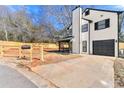 Exterior view of home showing the garage, long driveway, partial front yard, and new wood fence at 459 Orchard Dr, Stone Mountain, GA 30083