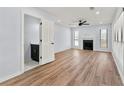 Spacious living room with wood floors, fireplace, ceiling fan, and access to a wet bar at 459 Orchard Dr, Stone Mountain, GA 30083