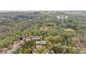 Aerial view of a residential neighborhood with tree-lined streets, showcasing the community's pool and tennis amenities at 107 Grand Ave, Suwanee, GA 30024