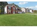 Beautiful two-story home featuring a well-maintained lawn and brick facade at 192 Palisade Point Dr, Ellenwood, GA 30294