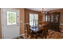 A dining room with wooden furniture, chandelier, and a decorative glass door at 210 Mels Way, Stockbridge, GA 30281