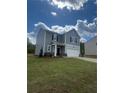 Two-story home with a neatly landscaped yard and driveway on a sunny day at 87 Sonoma Drive, Dallas, GA 30157
